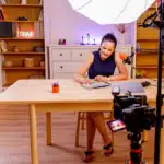 women sitting at desk writing and being recorded with broadcast AV